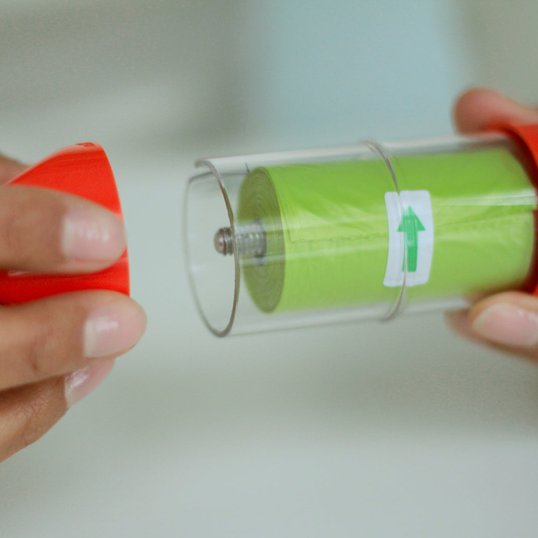 Assembling an orange LOOP poop bag holder#color_orange