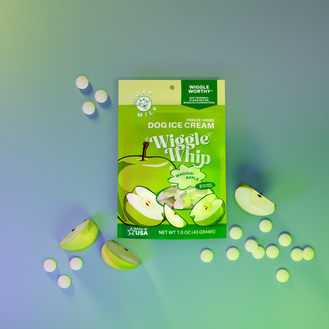 Waggin' Apple Wiggle Whip freeze-dried dog ice cream packaging with green apples on a gradient blue and green background