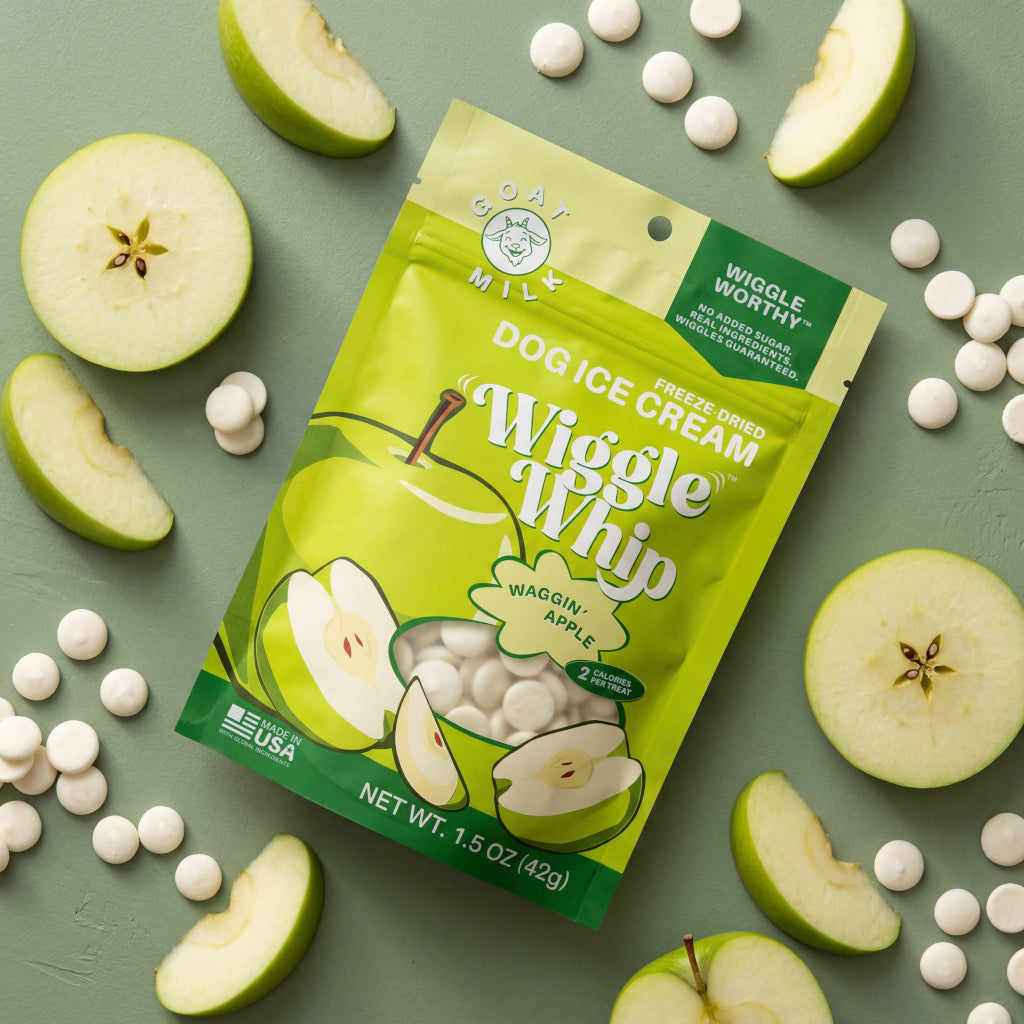 Wiggle Whip Freeze-Dried Dog ice cream package with apple slices and Wiggle Whip treats on a green background