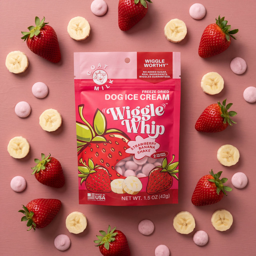 Dog ice cream package 'Wiggle Whip' with strawberries, bananas, and pink cookies on a pink background