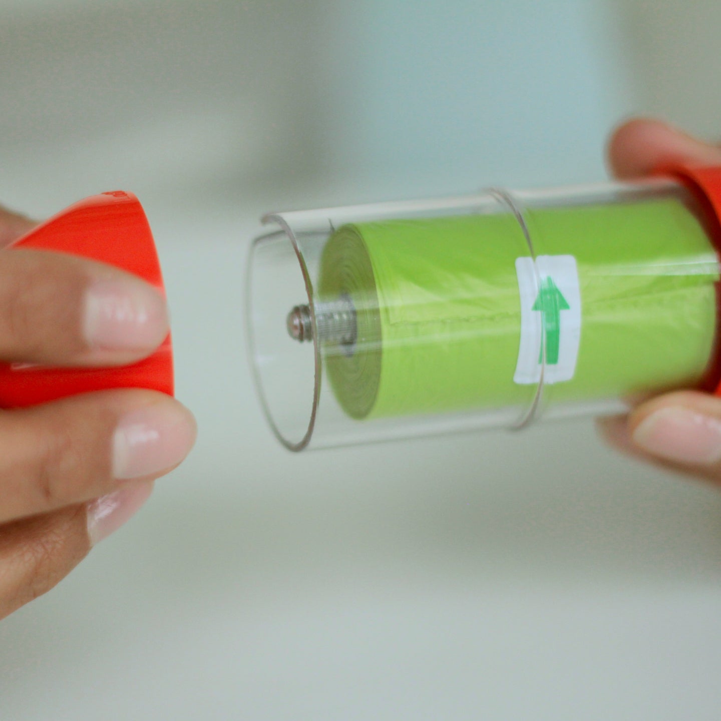 Assembling an orange LOOP poop bag holder#color_orange